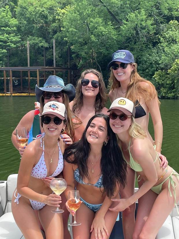 LakeTime guests posing together on a pontoon deck on Lake Austin