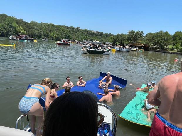 Group relaxing on the floating mat during a LakeTime charter