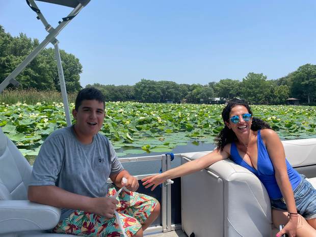 Guests enjoying the lily pads on a LakeTime Lake Austin pontoon trip