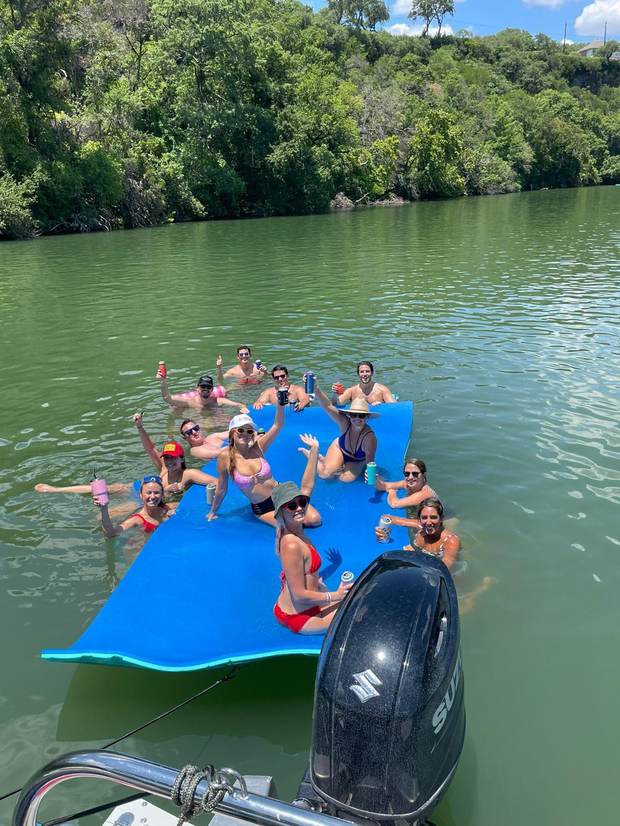 Large group floating and celebrating on Lake Austin with LakeTime