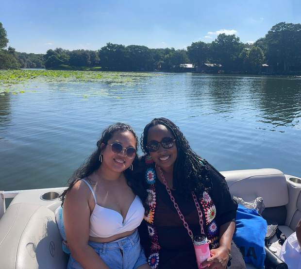 Guests relaxing together on a LakeTime pontoon near the lily pads