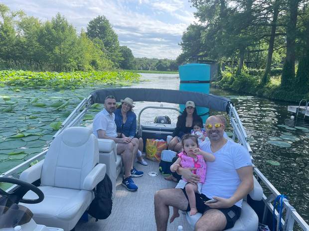 Family enjoying a relaxed afternoon aboard a LakeTime pontoon on Lake Austin