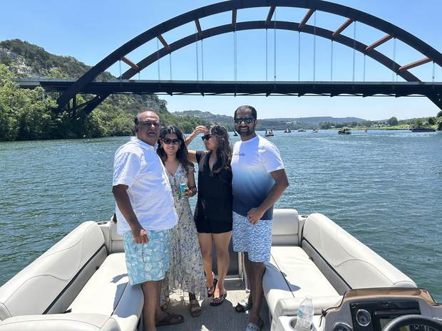 Family enjoying a Lake Austin boat rental near the 360 Bridge