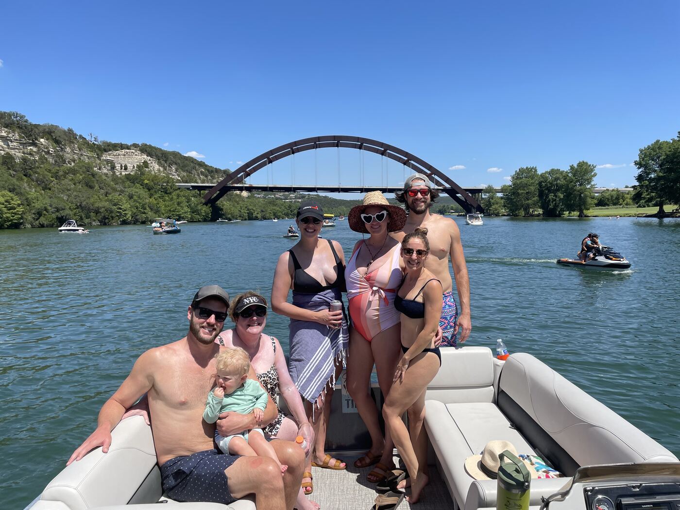 Couple relaxing on the floating mat off the LakeTime pontoon on Lake Austin