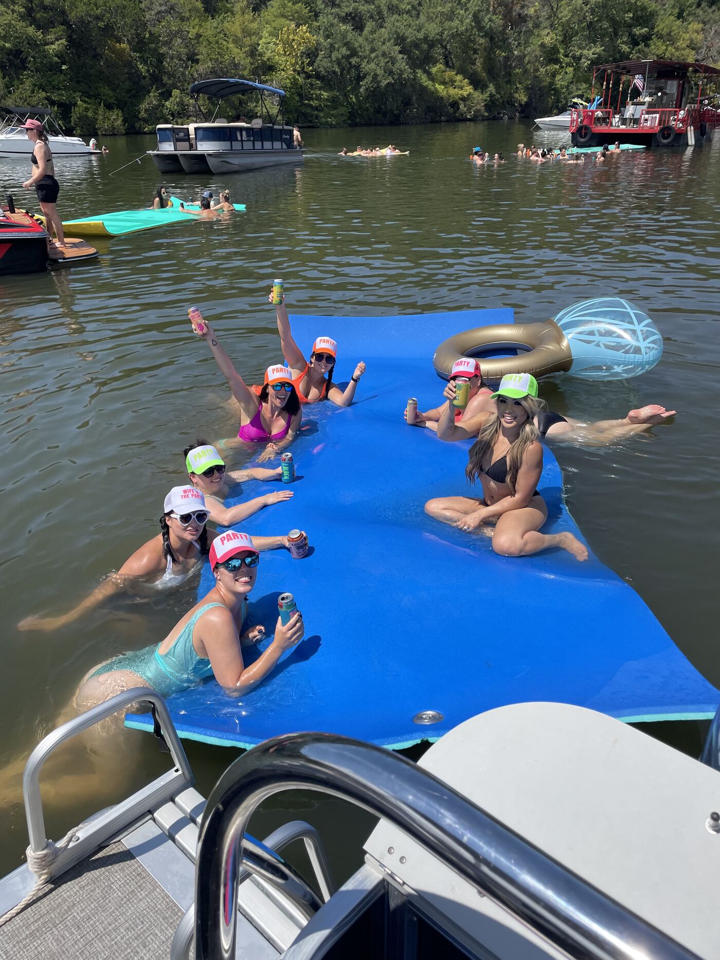 Family enjoying a sunset cruise aboard a LakeTime pontoon on Lake Austin