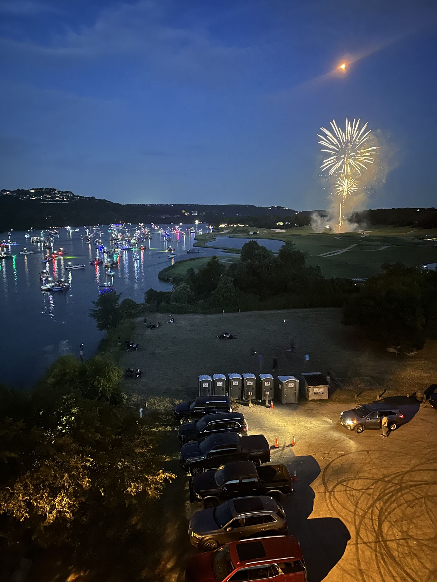 Lake Austin lit up with fireworks and boats during a night event
