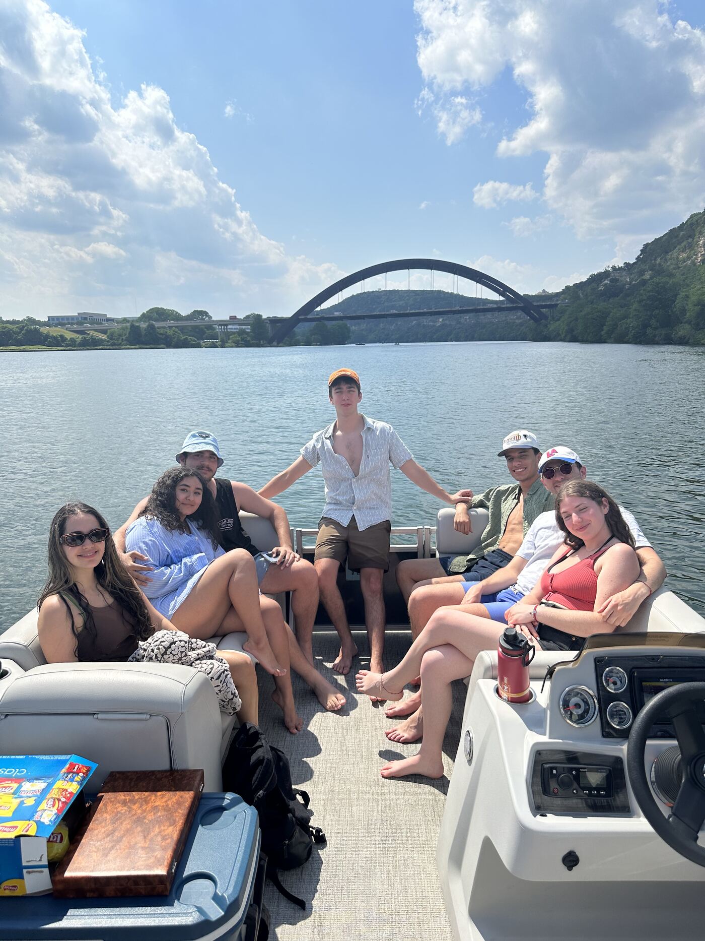Friends celebrating together on a LakeTime pontoon on Lake Austin