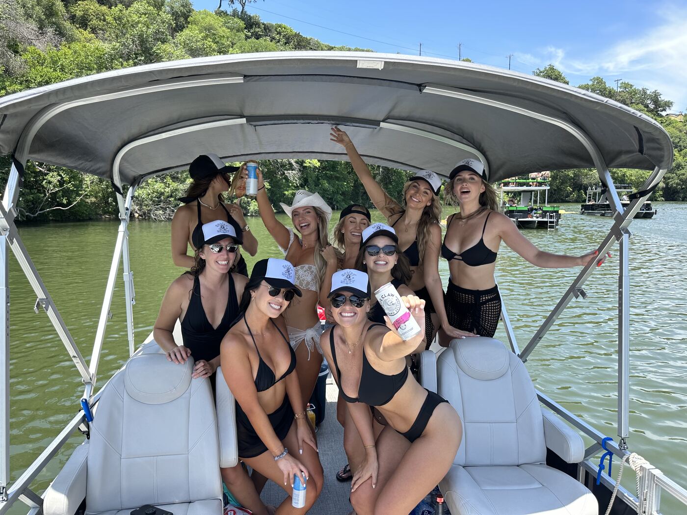 Group enjoying a sunny afternoon aboard a LakeTime pontoon on Lake Austin
