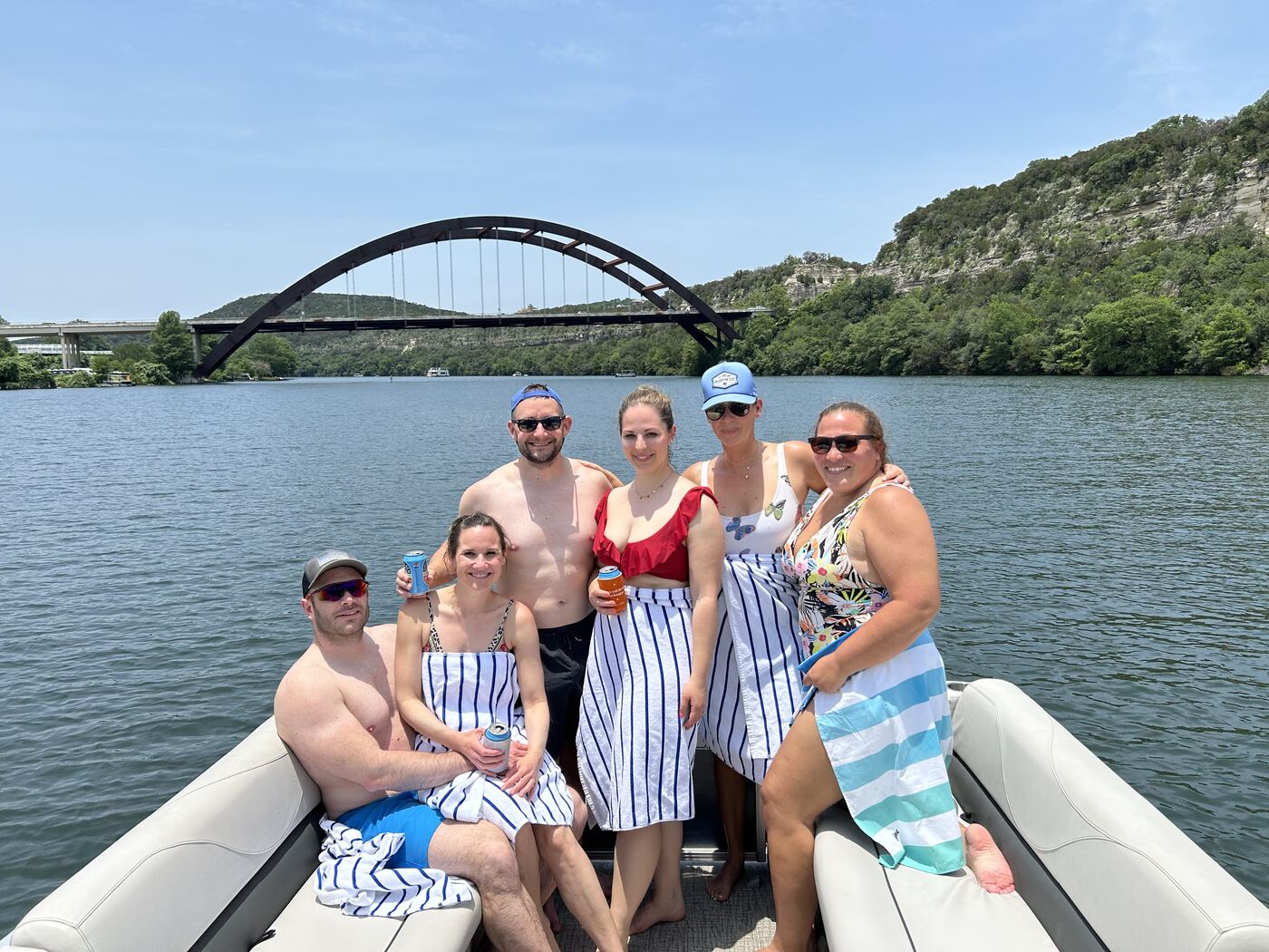Bachelor party group aboard a LakeTime pontoon near the 360 Bridge