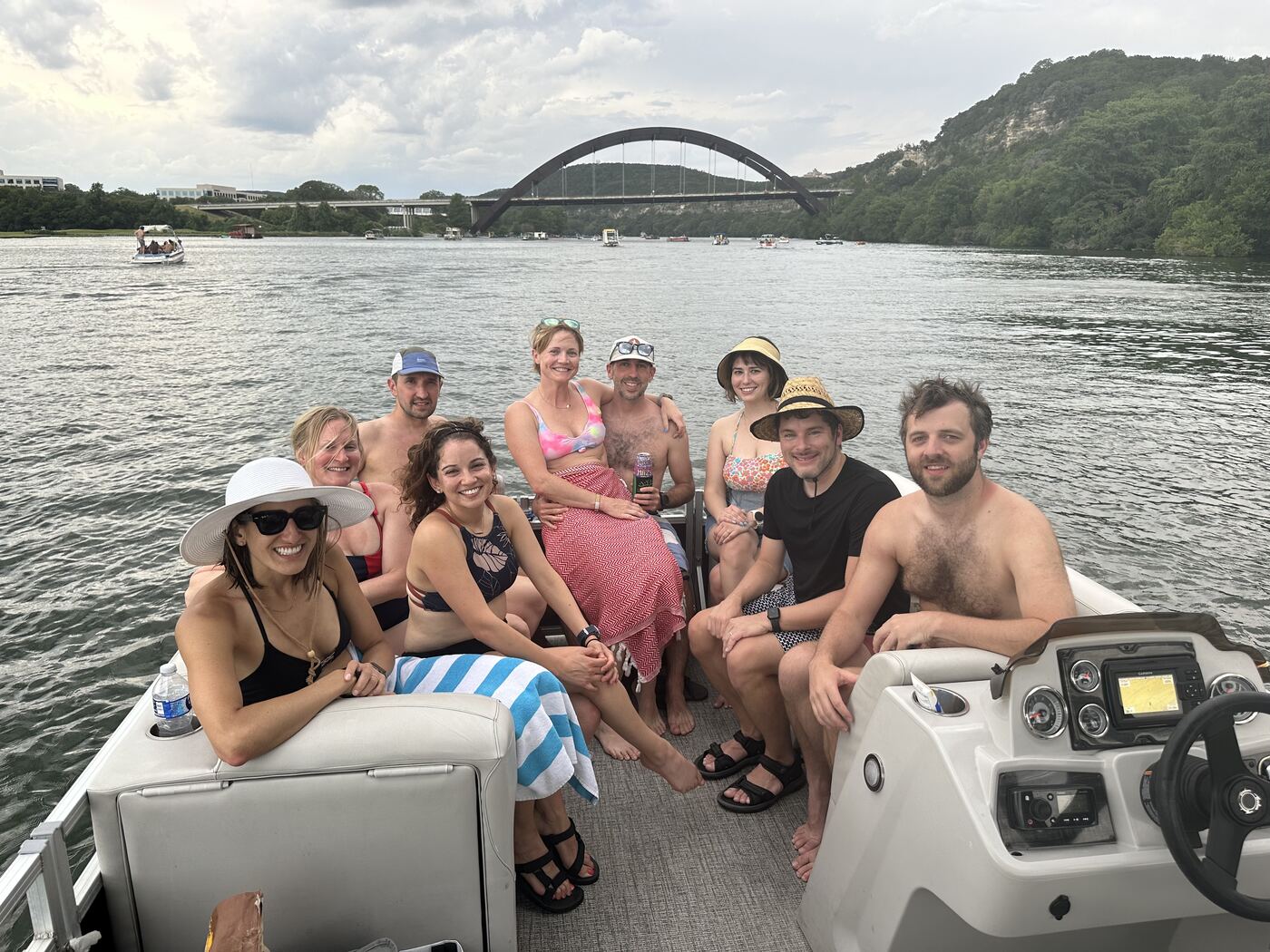 Friends wrapped in towels relaxing together on a LakeTime pontoon