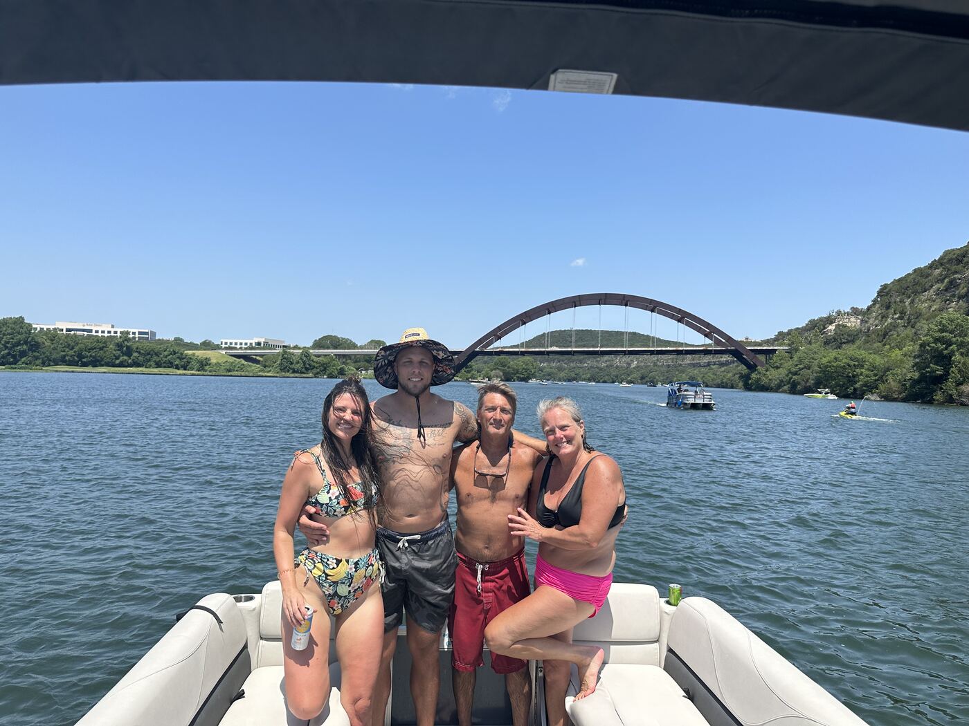 Group celebrating together on the floating mat off a LakeTime pontoon