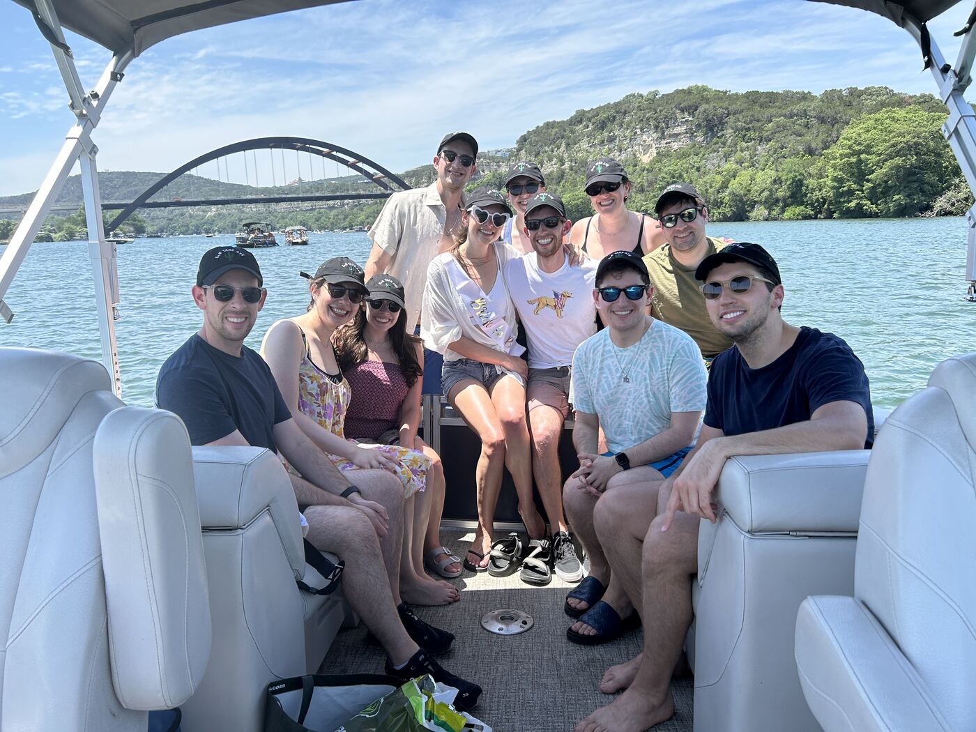 Bachelorette party posing under the bimini top of a LakeTime pontoon