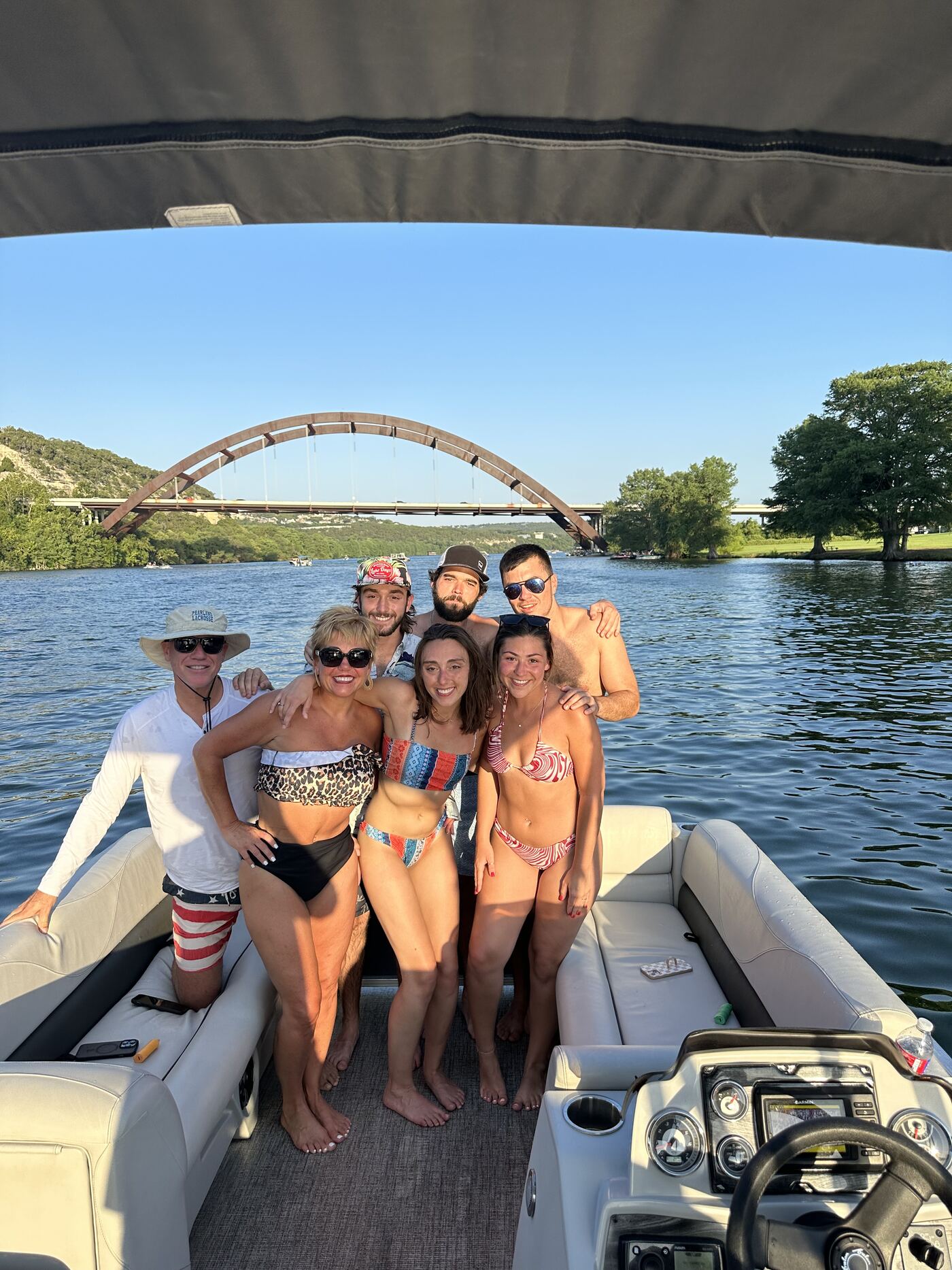 Group of friends enjoying a day out aboard a LakeTime pontoon on Lake Austin
